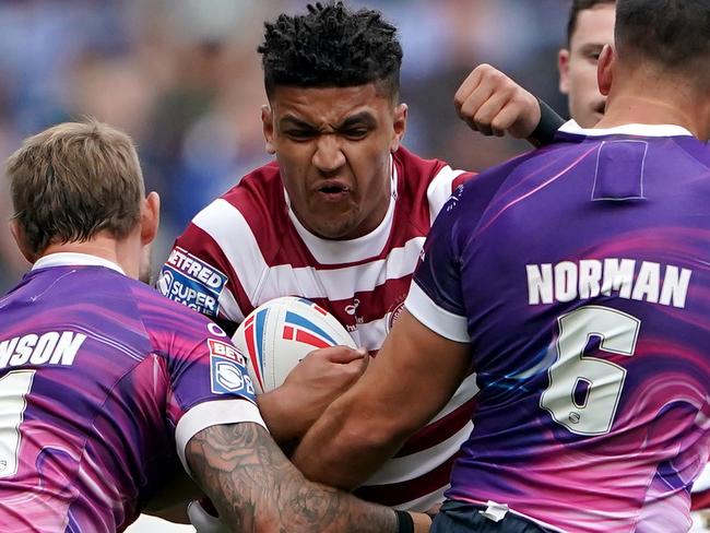 Wigan WarriorsÃâ¢ Kai Pearce-Paul is tackled by Toulouse OlympiqueÃâ¢s Chris Hankinson (left) and Corey Norman during the Betfred Super League match at the DW Stadium, Wigan. Picture date: Friday June 24, 2022. (Photo by Zac Goodwin/PA Images via Getty Images)