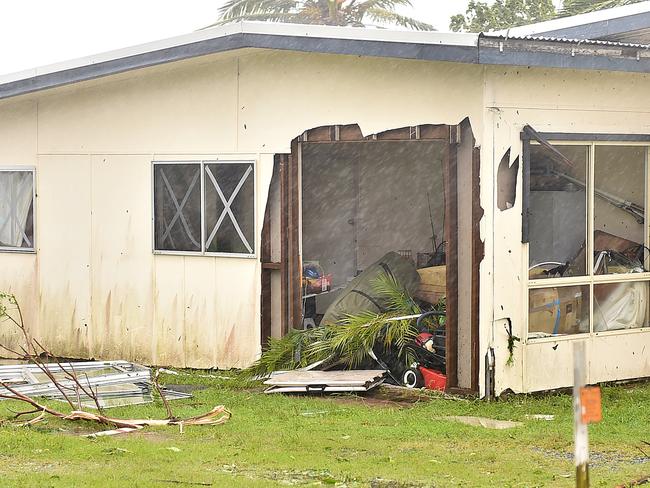 A house in Airlie is left with a gapping hole and a tree on the roof during Cyclone Debbie. Picture: Alix Sweeney