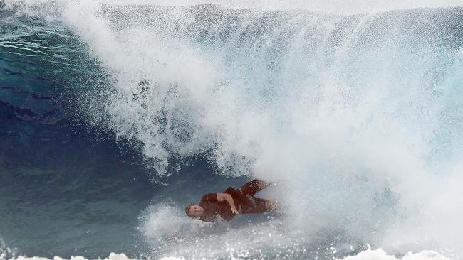 A surfer falls from his board at Snapper Rocks on the Gold Coast , Thursday February 21, 2019. Huge swells and high tides are set to pummelling south-east Queensland beaches over the coming days as Cyclone Oma tracks towards the Queensland coast. Photo: Dave Hunt/AAP.