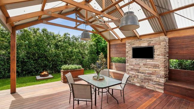 A big deck with a gabled roof created a spacious outdoor living space.