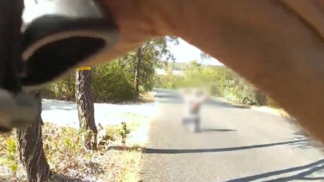 Body worn camera vision shows the shirtless man kneeling in the road as officers approach. Picture: WA Police