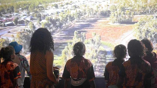 Artist Nickeema Williams and students from Woorabinda watch the exhibition videos. Picture: Jann Houley