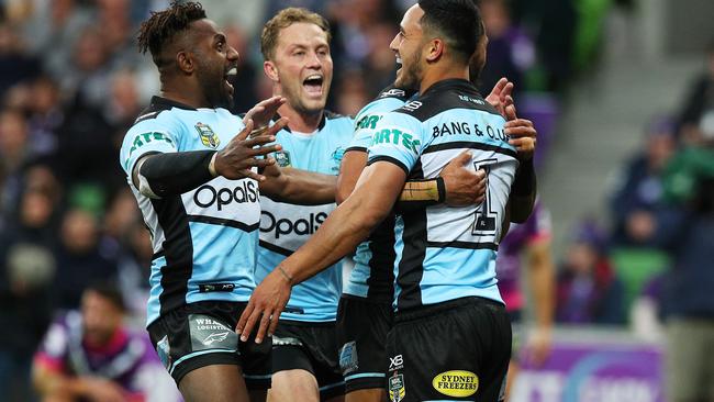 Valentine Holmes is congratulated by his Sharks teammates after scoring a try against the Storm. Picture: Getty Images