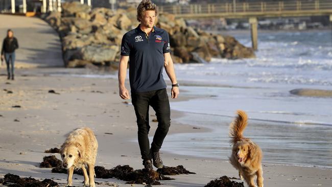 Rory Sloane at Brighton beach with his dogs Minka and Marli. Picture: Sarah Reed