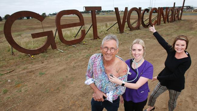 Villawood executive director Rory Costelloe, Barwon Health midwife Andrea Moore and Barwon Health Foundation executive Zoe Waters, getting the Get Vaccinated message across. Villawood has updated its Wandana Heights signage to say Get Vaccinated. Picture: Alan Barber