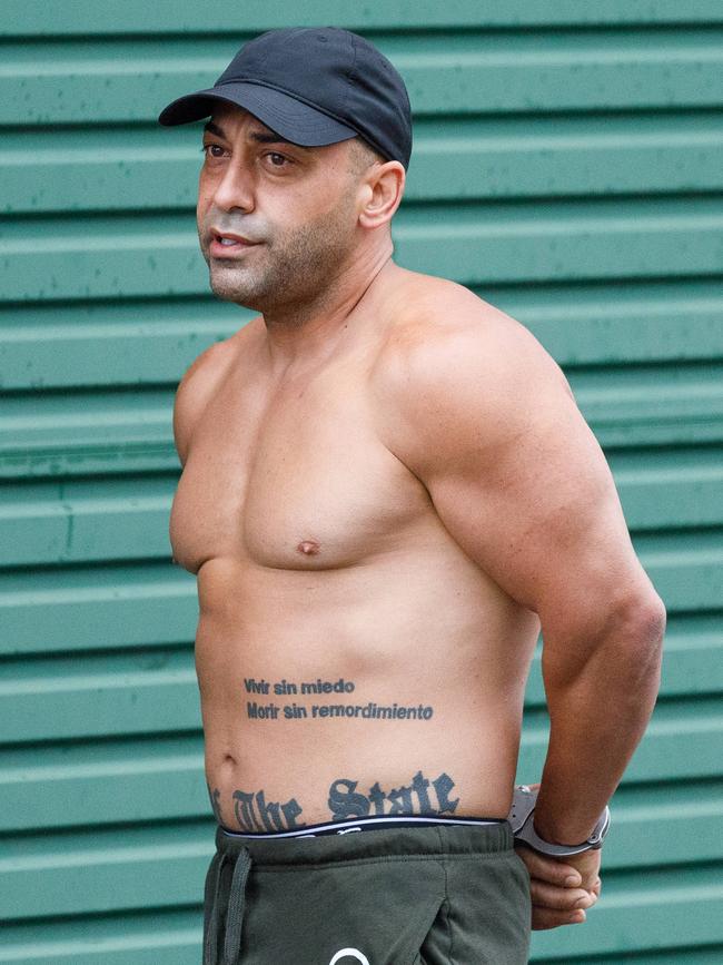 Ayman Manly is led out of the same Drummoyne property after also being arrested over the Greenacre shooting. Picture: Max Mason-Hubers