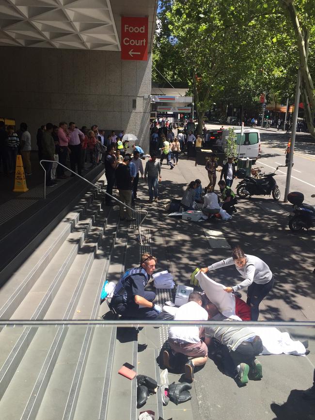 Bystanders help people hit by the car. Picture: Supplied