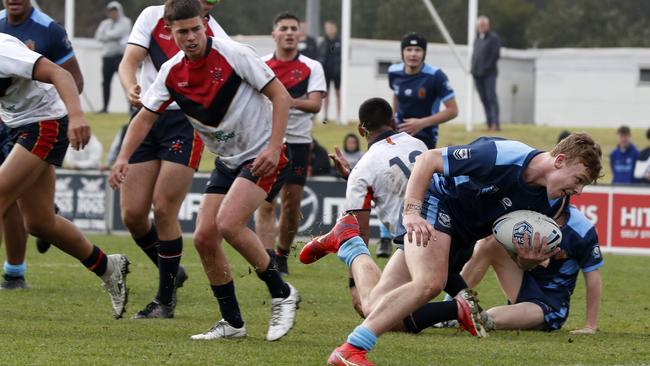 Bailey Peschka sneaks in for a try during the CHS and CIS clash. Picture: Jonathan Ng