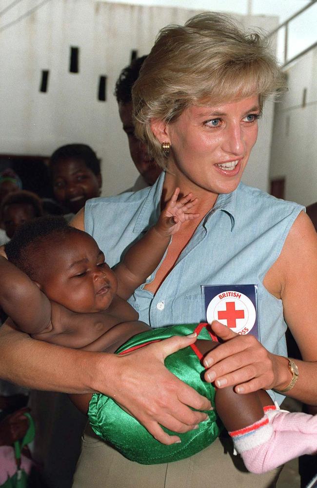 Diana holding a baby during a visit to The Orthopaedic Centre For Landmine Victims in Angola. Picture: Tim Graham