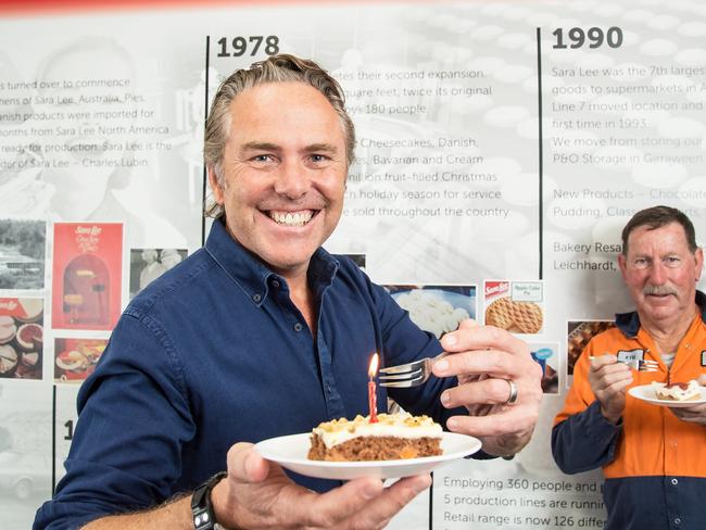 Sara Lee managing director Mark Mackaness and long-serving employee Kym Gurney celebrate the company’s 50th birthday at its Lisarow factory in 2021. Picture: Troy Snook