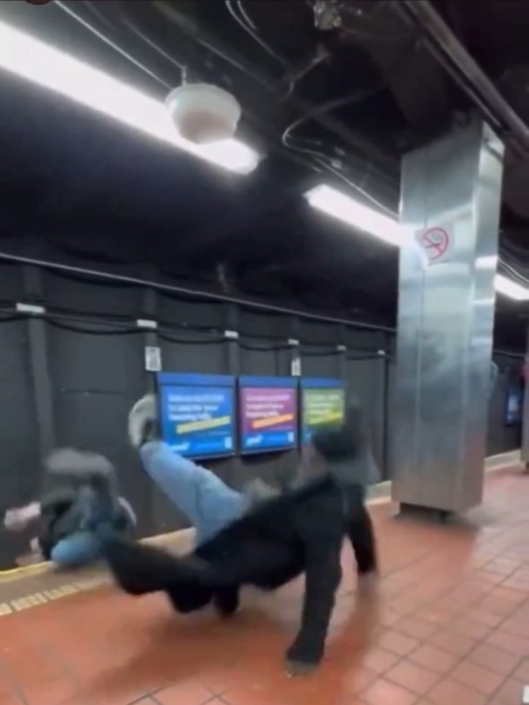 The man is seen falling onto the tracks after being punched.