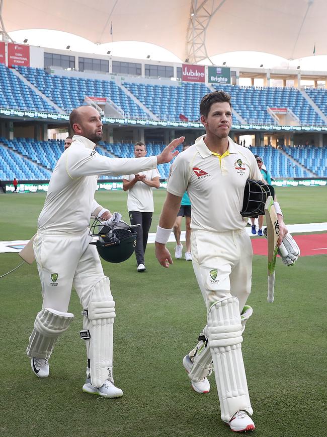 Nathan Lyon (left) gives Australian captain Tim Paine a pat on the back after the pair remained unbeaten to snare a draw against Pakistan. Photo: Getty Images