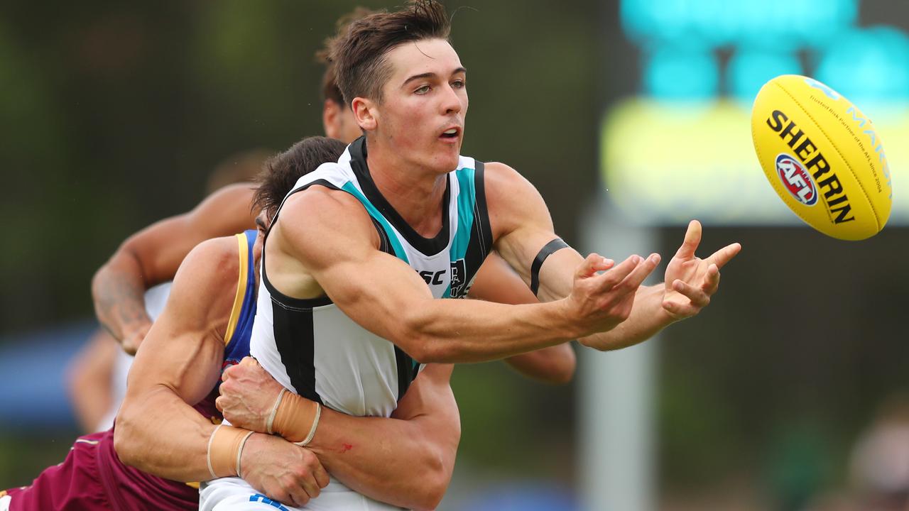 Young gun Connor Rozee fires off a handball after being tackled. Picture: Getty Images