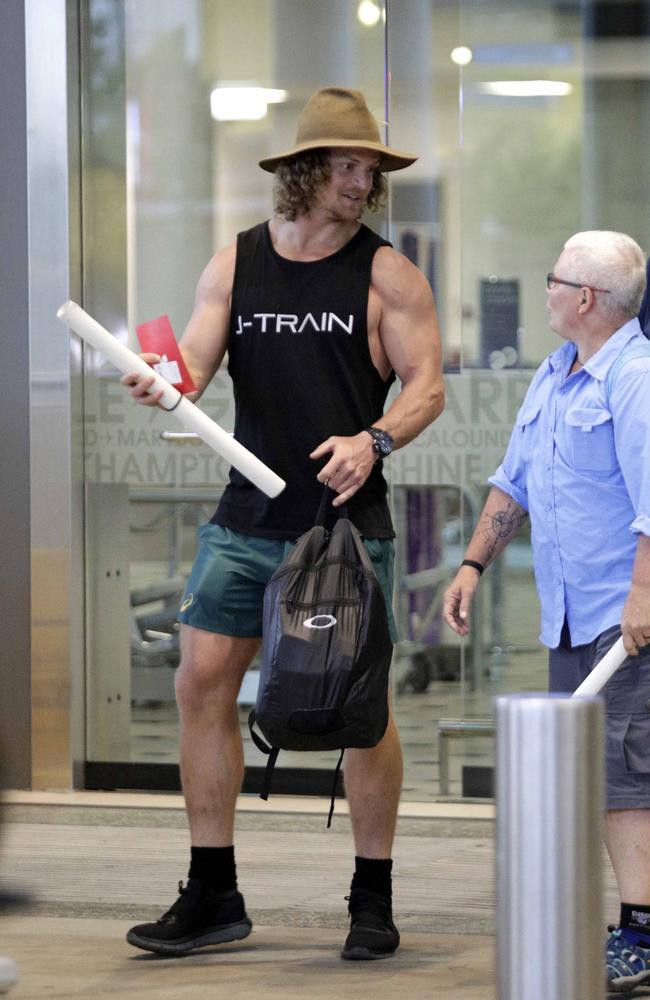 He was escorted through the airport by security. Picture: Diimex