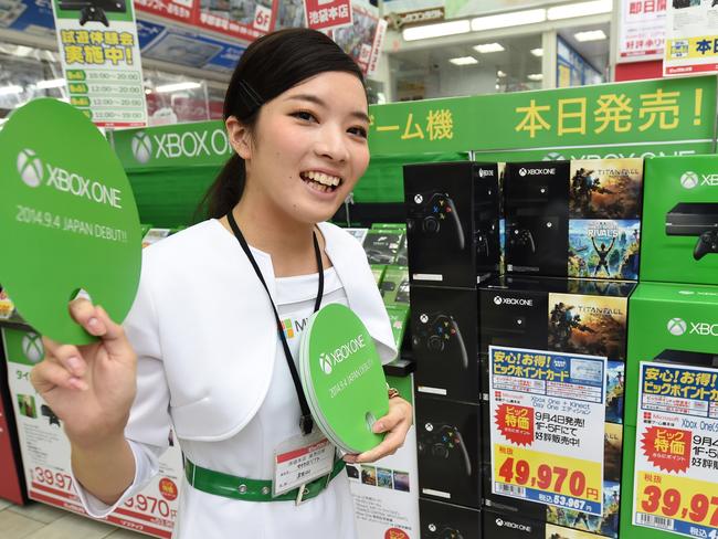 A campaign girl for Microsoft's video game console "Xbox One" promotes the console at the launch in Japan earlier this month. Picture: AFP PHOTO/Toru Yamanaka.