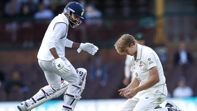 Mohammed Siraj rushes to the aid of Cameron Green.