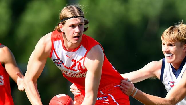 MELBOURNE, AUSTRALIA - APRIL 28: Joe Pike of the Young Guns handballs whilst being tackled during the 2024 Young Guns Series match between the Young Guns and the Victoria Country U18 Boys at Highgate Recreation Centre on April 28, 2024 in Melbourne, Australia. (Photo by Josh Chadwick/AFL Photos)