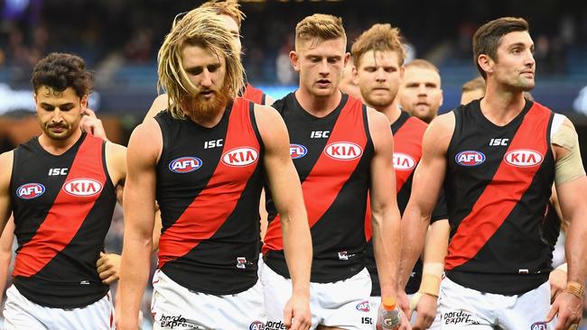 Dyson Heppell leads Essendon off the MCG after losing to Carlton.