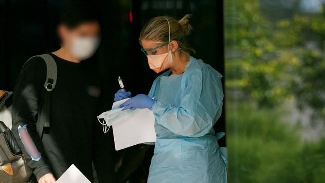 Patient in mask been seen by triage nurse at Northern Beaches Hospital's new COVID-19 clinic. Picture: Tim Pascoe