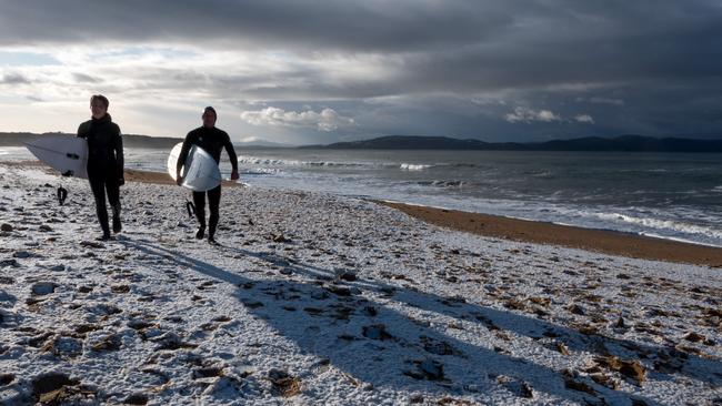 Surfers in the snow at Clifton Beach. Photo Doug Thost
