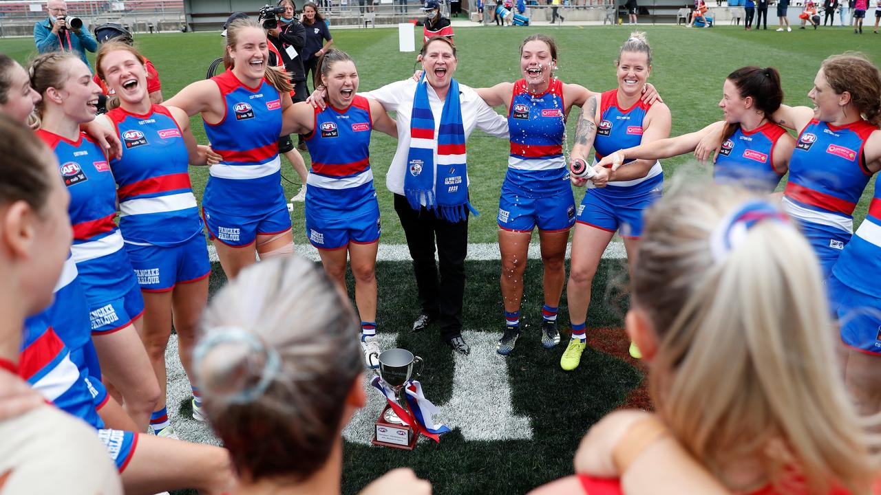 Bulldogs players sing the club song on the field after defeating Melbourne.