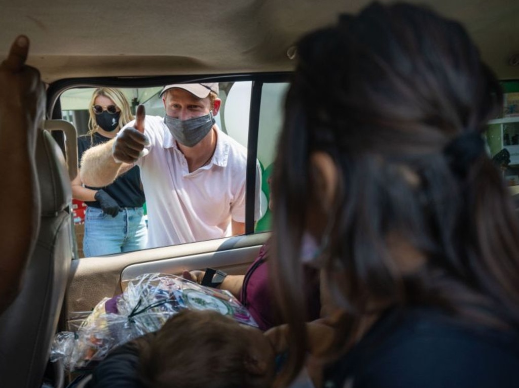 Prince Harry gives the thumbs up as hands out the much needed supplies. Picture: Baby2Baby/Instagram