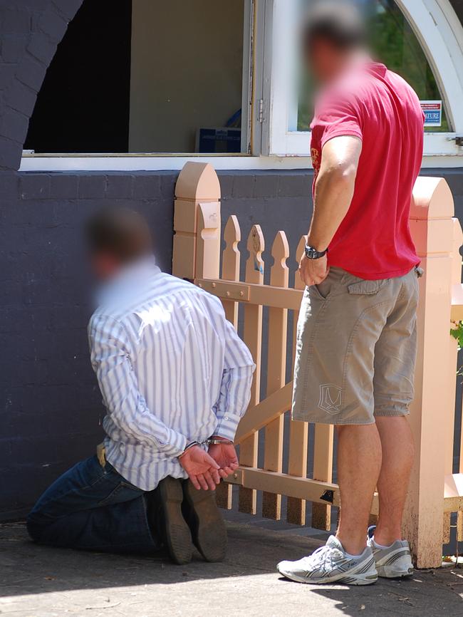 Anthony Perish (kneeling) is arrested.