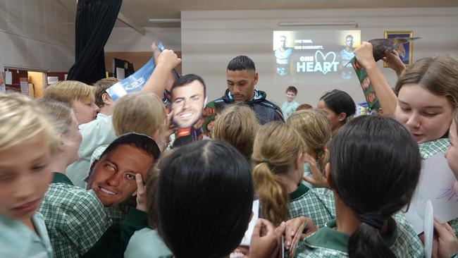 Cronulla Sharks NRL player Jesse Ramien is mobbed for autographs during a visit to Mary Help of Christians Primary School at Coffs Harbour ahead of the Indigenous Round match against the Newcastle Knights. Picture: Chris Knight