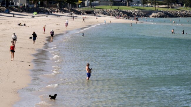 Beachgoers at Glenelg Beach on Thursday, trying to cool off. Picture: AAP / Kelly Barnes