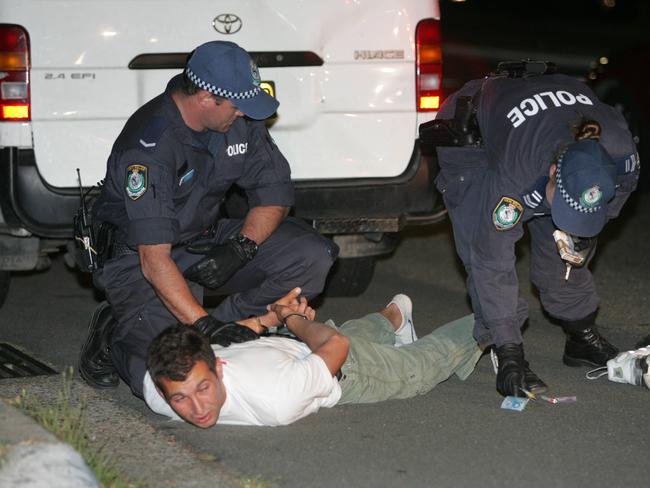 A man is arrested by police.