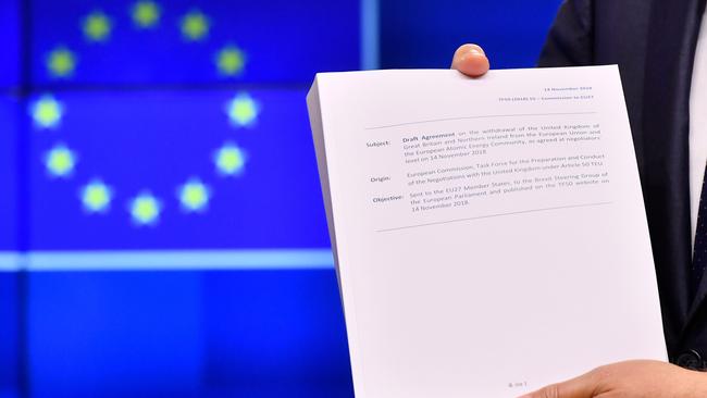 European Council President Donald Tusk holds the draft agreement of the withdrawal of the United Kingdom from the European Union.