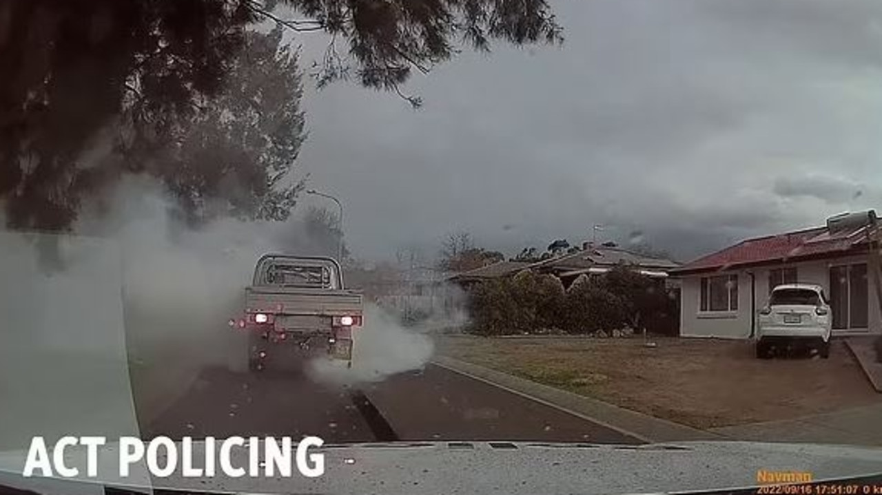 A driver does a burnout in front of police car. Picture: ACT Policing