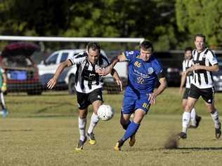 CLOSE BATTLE: Willowburn's Peter Millican (left) competes for the ball with USQ FC's Brendan Willmot. Willowburn was the only team to beat minor premiers USQ this season. Picture: Kevin Farmer