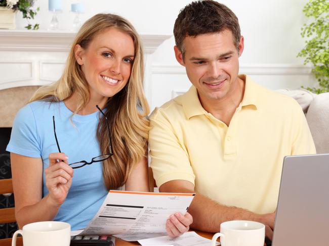 A couple with their bills who are discussing their finances including their home loan. Picture: iStock.