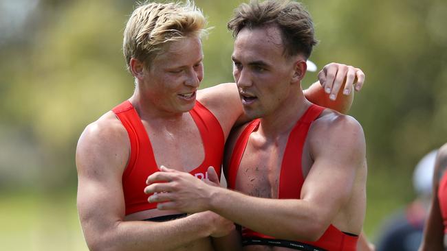 Sydney recruit Ryan Clarke gets some advice from Isaac Heeney after his first training session with the Swans.