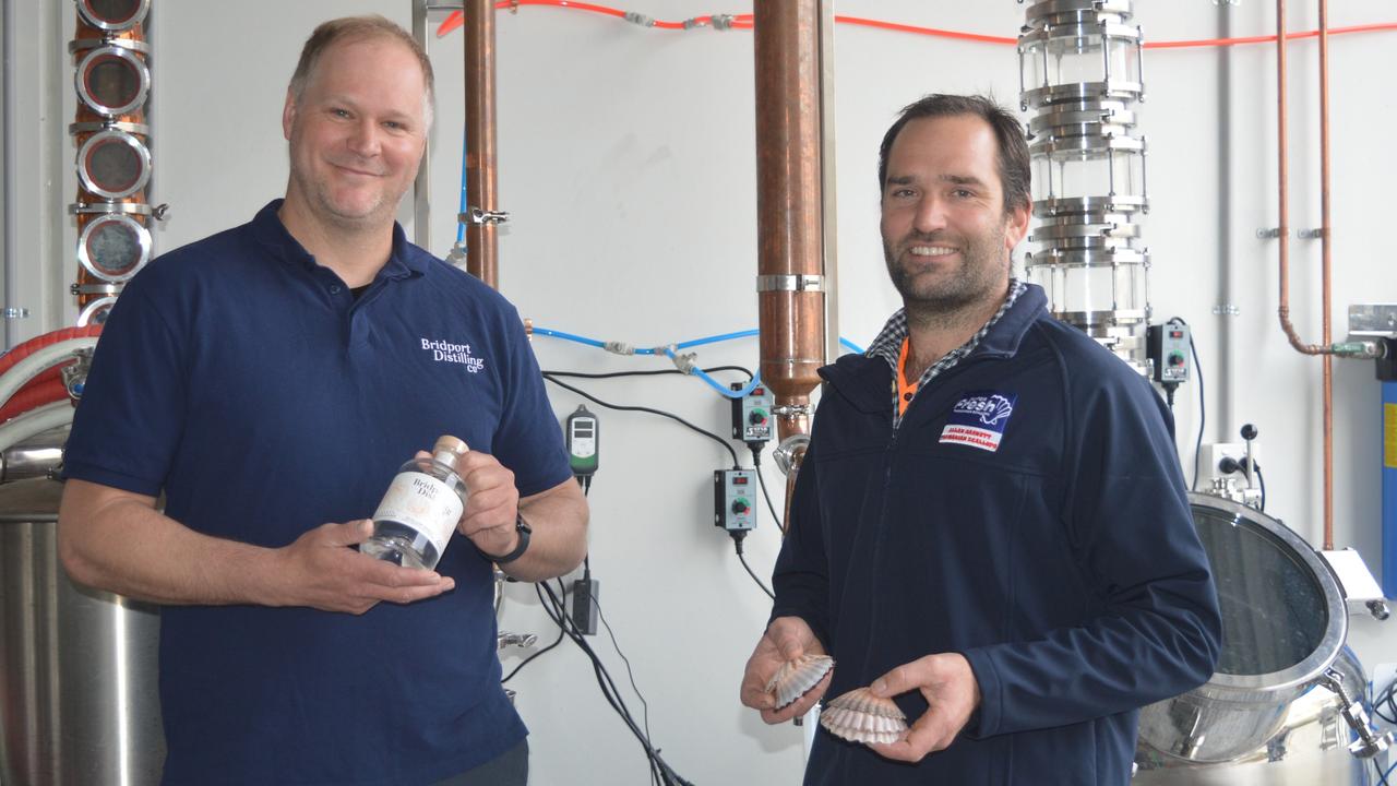 Jacob Stanford, manager of Allan Barnett Fishing Co, and Bridport Distilling Co owner Chris Carins launching the company's scallop shell gin. Picture: Taylor Cline