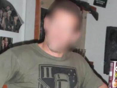 Picture believed to be of Major (now Colonel) Matthew Stevens [standing] performing lewd acts.  The senior SAS officer and a non-commissioned officer, kneeling, pretend to engage in a sex act using an object designed to look like a penis at a party in the makeshift Fat Ladies Arms bar.