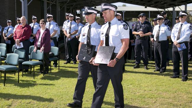 Senior constable David Ray, right, carries the memorial stone for Jeru.