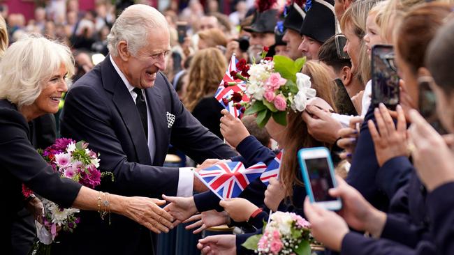 King Charles III and Camilla, Queen Consort, get to grips with wellwishers as they arrive at Hillsborough Castle in Belfast on Tuesday. Picture: AFP