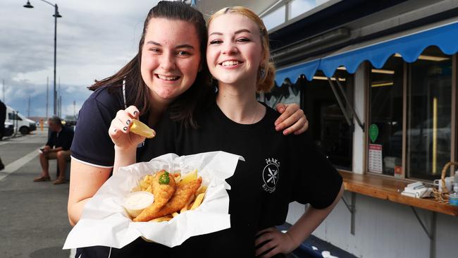 Yvette Duhig and AJ Richardson staff members from Mako and Fishy Business fish punts on the Hobart waterfront. They locals to help support them with no major events bring the usual big crowds to the waterfront area over Summer. Picture: NIKKI DAVIS-JONES