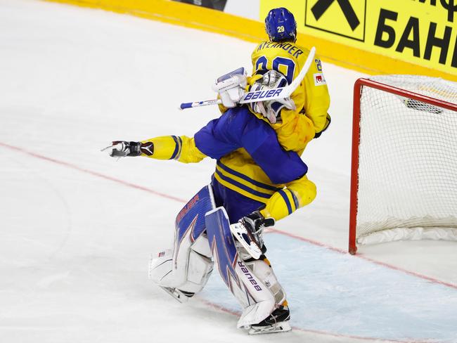 Sweden's William Nylander celebrates with Henrik Lundqvist after the shootout.