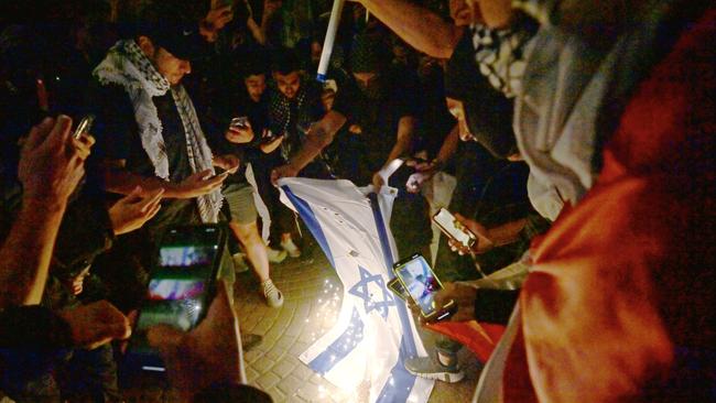 The Israeli flag is burned on the forecourt of Sydney Opera House shortly after war broke out between Israel and Palestine last year. Picture: NCA NewsWire / Jeremy Piper