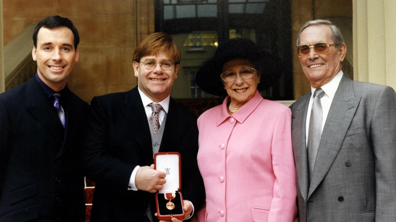 Elton John with David Furnish, his mother Sheila and stepfather Fred Fairebrother outside Buckingham Palace after being knighted by the Queen.