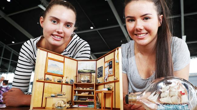 Myneika Morrow, 17, and Nicole Ross, 17, both of Launceston, with some of the boats in bottles that formed part of a record attempt. Picture: NIKKI DAVIS-JONES