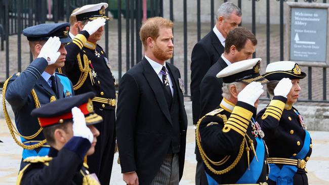 Prince Harry (and Peter Phillips) don’t join in as everyone else salutes the Queen. Picture: Hannah McKay / POOL / AFP