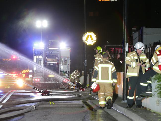 A group of shops and businesses have been destroyed by fire overnight. NSW Fire Brigade were called to Bankstown Railway Station after shops on a rail bridge overpass were well alight. A third alarm response was ordered to prevent the fire spreading. Rail lines were shut down briefly as a precaution. Pics Bill Hearne