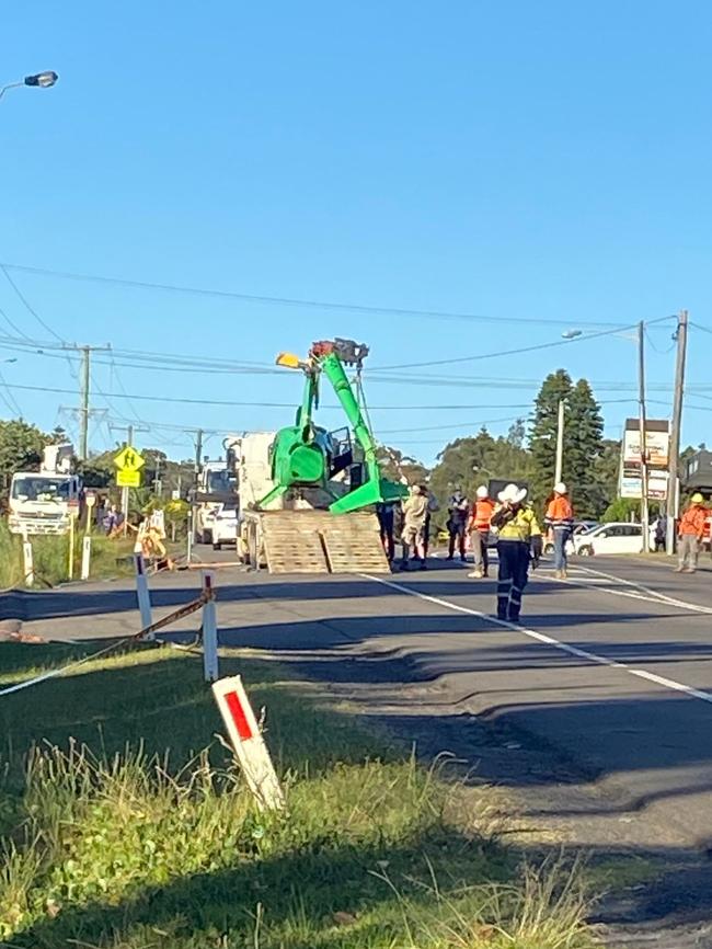 Image of the helicopter being removed at Forresters Beach. Picture: Rebecca Thompson