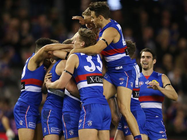 The Dogs converge on debutant Rhylee West after his maiden goal. Picture: Michael Klein