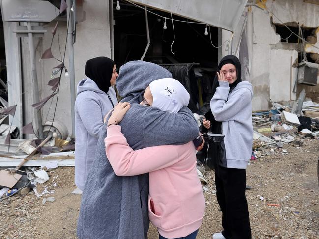 Women greet each other as displaced people make their way back to their homes in the south of Lebanon after a ceasefire between Israel and Hezbollah. Picture: AFP