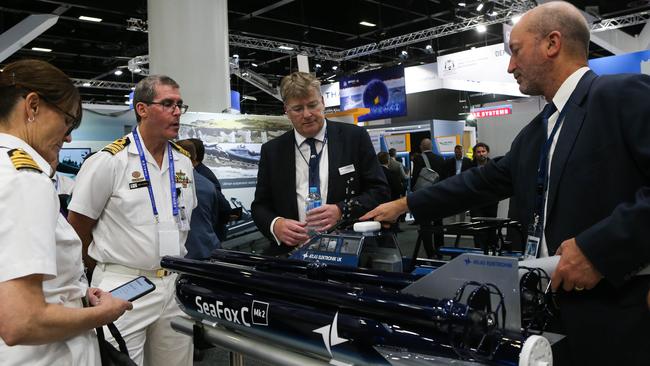 Navy officers discuss the new technology and equipment on display at the 2022 National Maritime Exhibition, Sydney, in May. Picture: NCA Newswire/Gaye Gerard